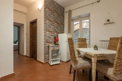 a kitchen with a table and chairs and a brick wall at Good Vibes apartment nel centro storico in Palermo
