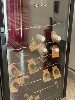 a refrigerator with wine bottles and labels on it at CASA CRETTO in Salaparuta