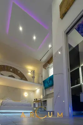 a room with a ceiling with purple lights at ARCUM suites in Palermo