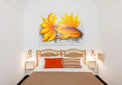 a bedroom with a bed with a painting on the wall at Alchimiammare 
