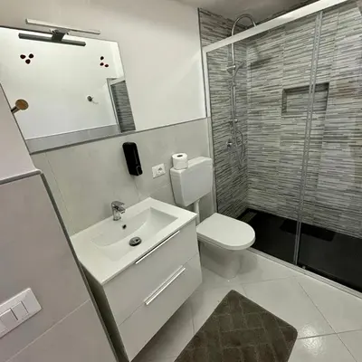 a bathroom with a toilet and a sink and a shower at Casa vacanze La Bonta' di Palermo in Palermo