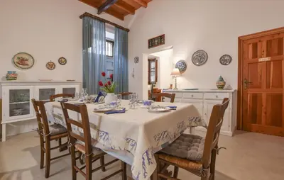 a dining room with a table and chairs and a kitchen at Stunning Home In Trappeto With Wifi in Trappeto