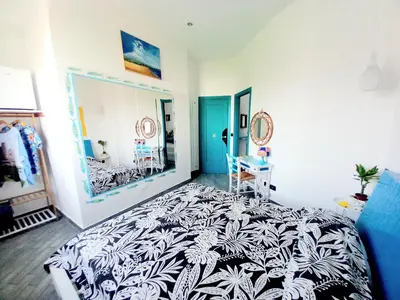 a bedroom with a black and white bed and a mirror at Villa Mondello Jacuzzi Room e Terraces Room in Mondello