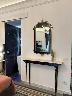 a mirror on a wall with a table at Maqueda view in Palermo