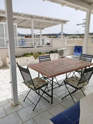 a table and chairs sitting on a patio at Casa Lisa in San Vito lo Capo