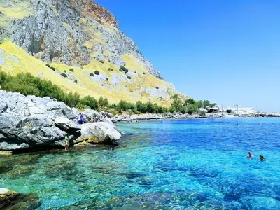 a group of people swimming in a body of water at Ashur 163 - Mondello in Palermo