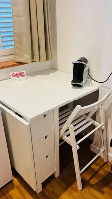 a white desk with a chair next to a window at Ashur 163 - Mondello in Palermo
