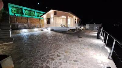 a house with a tub on a deck at night at Villini AltaVista in Altavilla Milicia