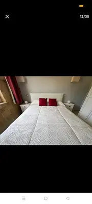 a bedroom with a bed with two red pillows at La casa di maretta,Mondello in Palermo