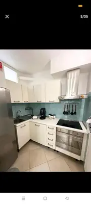 a kitchen with white cabinets and a stove top oven at La casa di maretta,Mondello in Palermo