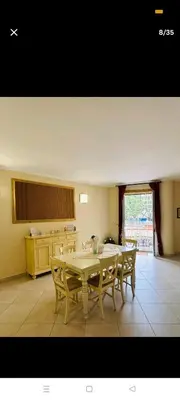a dining room with a table and chairs and a kitchen at La casa di maretta,Mondello in Palermo