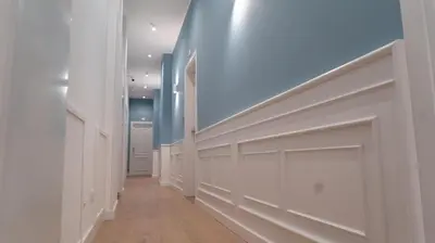 a hallway with white walls and a blue ceiling at Manere Suites in Palermo