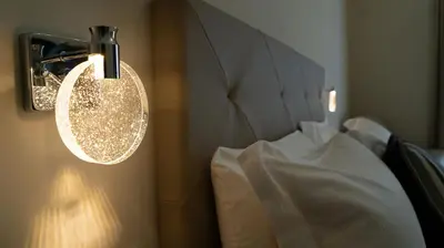 a light hanging on the wall next to a bed at Manere Suites in Palermo