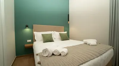 a bedroom with a bed with towels on it at Manere Suites in Palermo