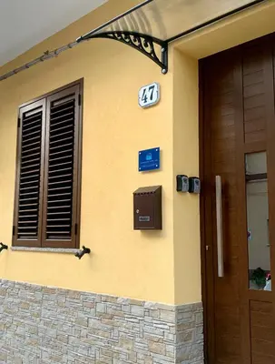 a front door of a house with a sign on it at Campofelice Happy Casa in Campofelice di Roccella