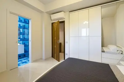 a bedroom with a bed and a bathroom at Villa Bizzarria in Castellammare del Golfo