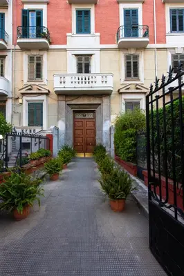 a door to a building with potted plants in front of it at Libertà 78 - Art Suite & Spa in Palermo
