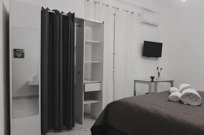 a bedroom with a bed and a television in it at Mariblu Palermo in Palermo