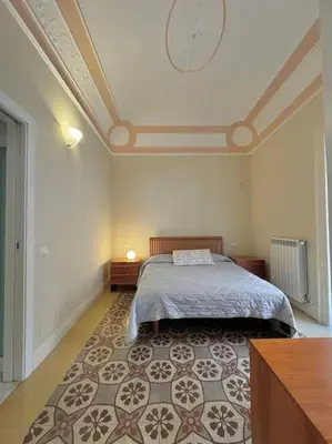 a bedroom with a bed and a clock on the ceiling at La casa di Alice Palermo Casa Professa in Palermo