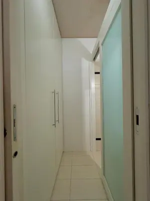 a hallway with white walls and a mirror at La casa di Alice Palermo Casa Professa in Palermo