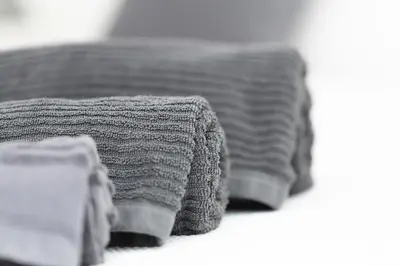 a bed with two towels on top of it at Massim'home in Palermo