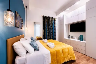 a bedroom with a bed with a yellow blanket at Oasi Libertà in Palermo