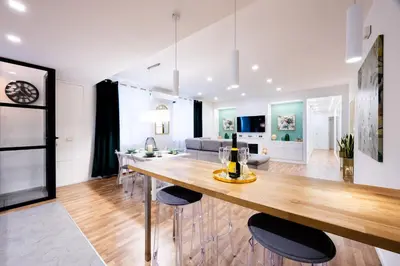 a kitchen and living room with a large wooden table at Oasi Libertà in Palermo