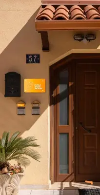 a building with a door and a sign on it at Calasole House: Mare a 2 Passi in San Vito lo Capo