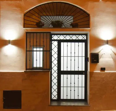 a door in a room with two lights on the wall at M&F Home in Palermo