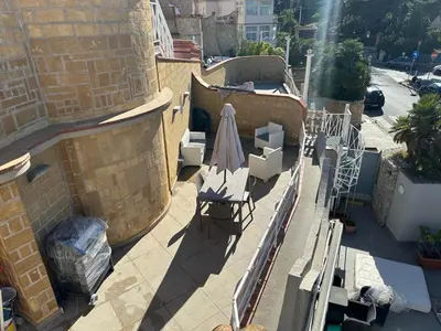 a patio with a chair and an umbrella on a building at La Casa di Anna, Mondello in Palermo