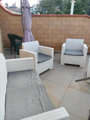 a patio with two chairs and an umbrella at La Casa di Anna, Mondello in Palermo