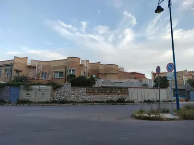 an empty street in front of a brick building at La Casa di Anna, Mondello in Palermo