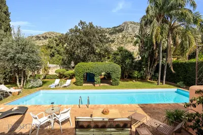 a swimming pool in a yard with a house at Casa Mediterranea Attitudine By DomuSicily in Mondello