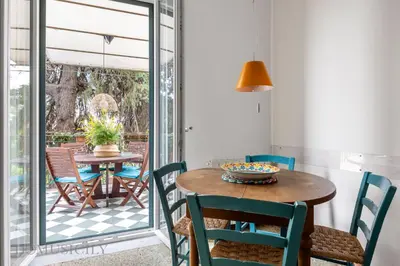 a dining room with a table and chairs at Buffa Apartaments by DomuSicily in Mondello