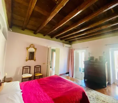 a bedroom with a large bed with a red blanket at casetta mon amour in Palermo