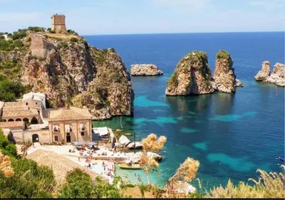 a house on a cliff next to the ocean at Villa Nuccia Oasi di relax con piscina in Castellammare del Golfo