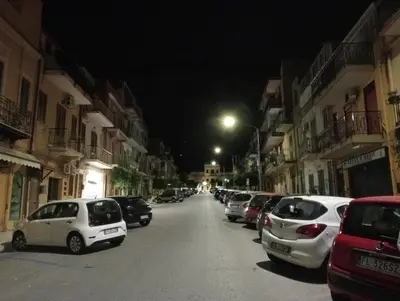 a group of cars parked on a street at night at Casa giambona in Capaci