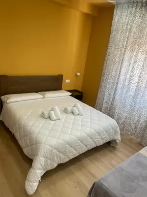 a bedroom with a bed with two towels on it at Central Empire in Palermo