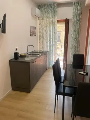 a kitchen with a sink and a table with chairs at Central Empire in Palermo