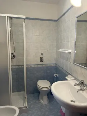 a bathroom with a toilet and a sink and a shower at A Casa di Amy 2.0 in Macari