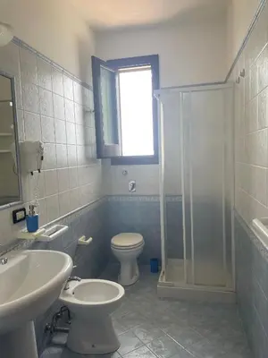 a bathroom with a sink and a toilet and a shower at A Casa di Amy 2.0 in Macari