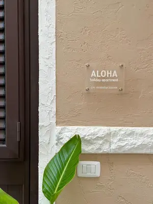 a sign on the side of a building at Aloha in Palermo