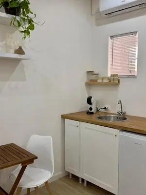 a kitchen with a sink and a wooden counter top at Aloha in Palermo