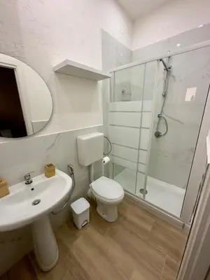 a bathroom with a toilet and a sink and a shower at Aloha in Palermo