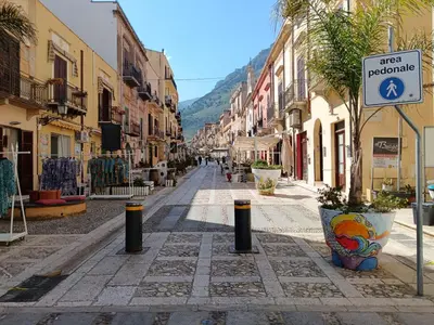 an empty street with a sign in a town at La Casetta di Nino in Castellammare del Golfo