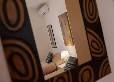a reflection of a living room with a couch in a mirror at Villa Laura in Balestrate