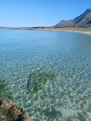 a large body of water with a rock in the water at Alykè Appartamenti Vacanze Macari in Macari