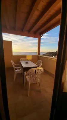 a table and chairs on a balcony with a view at Alykè Appartamenti Vacanze Macari in Macari