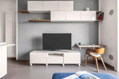 a living room with a tv and a white desk at FronteMare in Palermo