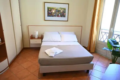 a bedroom with a bed with a towel on it at Politeama Theater Apartments in Palermo
